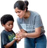 A woman showing a young boy a reptilian in her hands.
